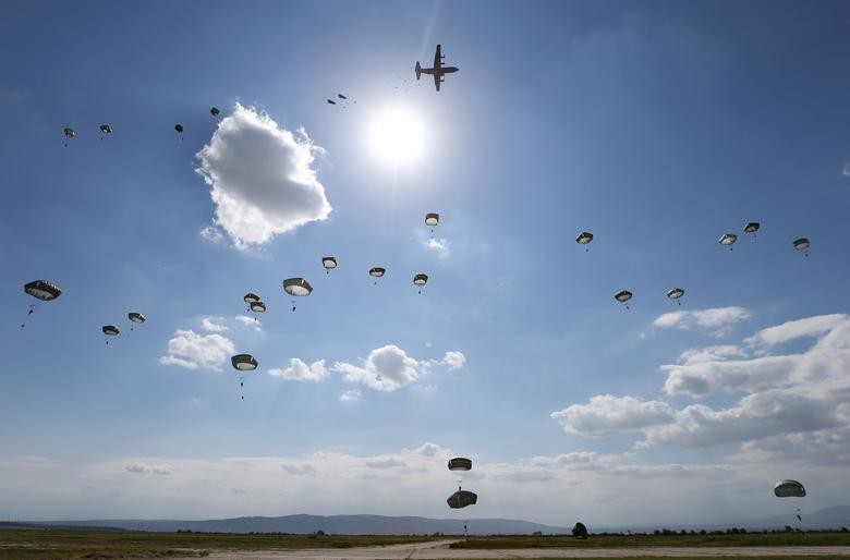 U.S. Army paratroopers jump with parachutes from a Hercules C-130 military transport plane during Noble Partner 2020 multinational exercise, which involves servicemen from Georgia, the United States, the United Kingdom, Poland and France, at Vaziani military base outside Tbilisi, Georgia. REUTERS/Irakli Gedenidze
